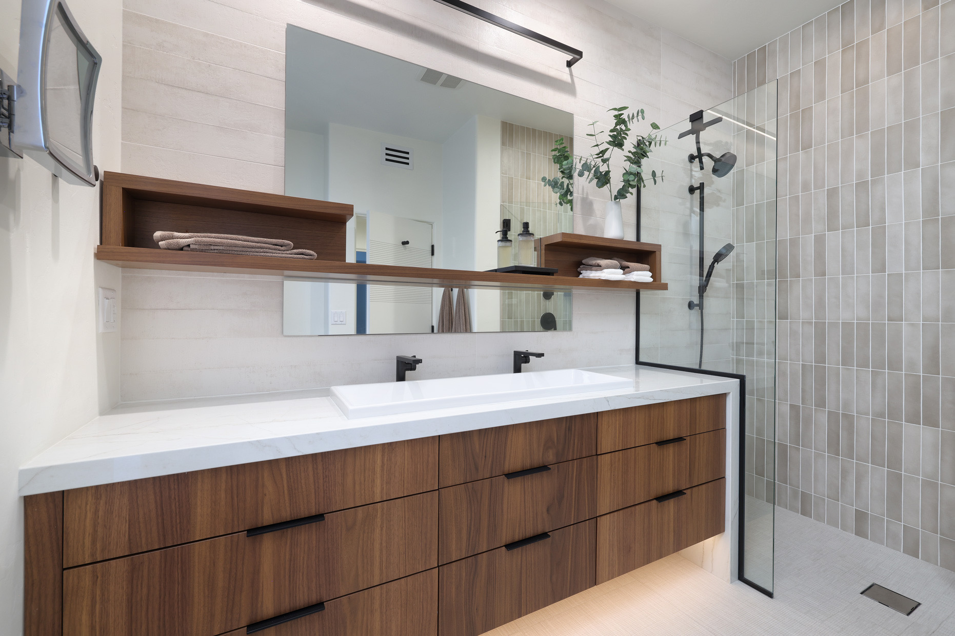 Warm wood cabinetry and stone detailing in the Desert Modern residence
